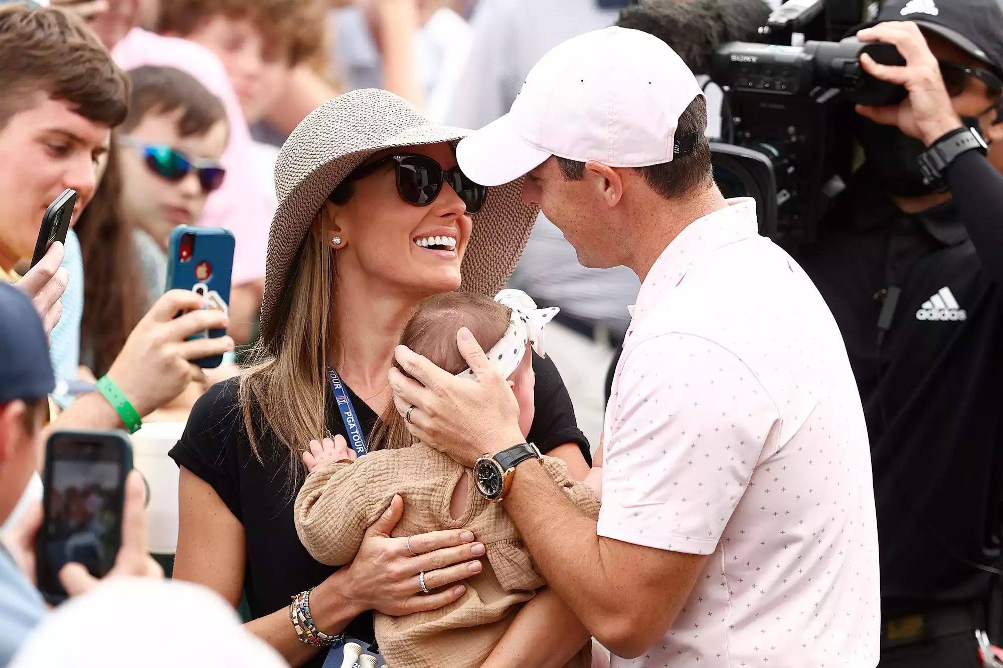 rory mcilroy and his wife with their daughter.